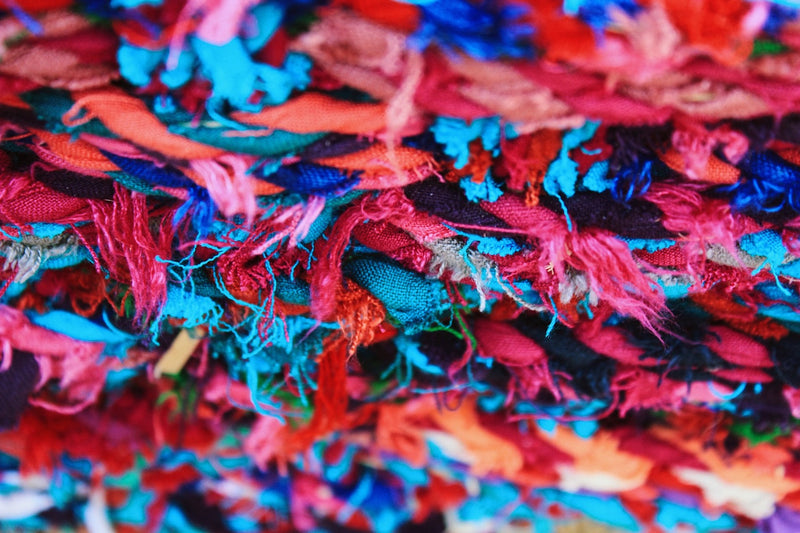 Shredded multi-color cotton strips waiting to be recycled