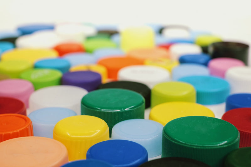 multi color plastic bottle tops waiting to be recycled